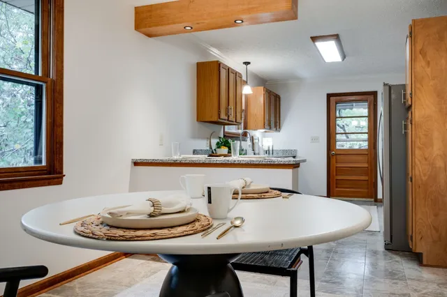 a dining room with furniture and window