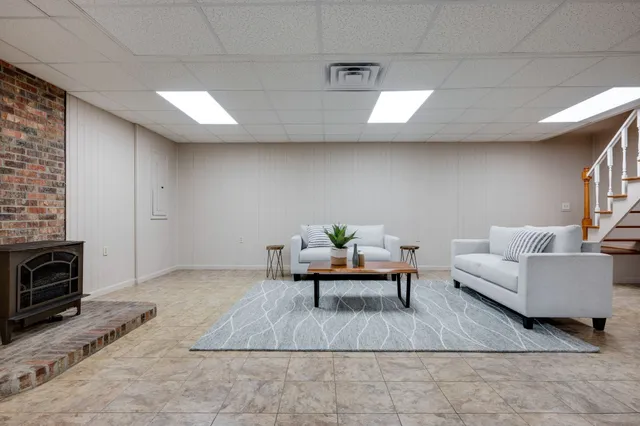 a living room with furniture and a fireplace