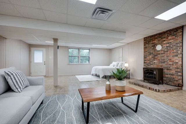 a living room with furniture a fireplace and a table