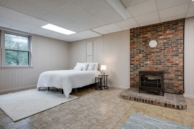 a bedroom with a bed and a fireplace