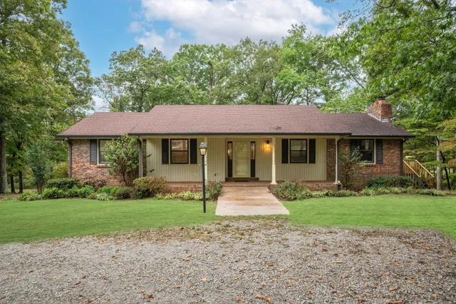 a front view of a house with a garden and porch
