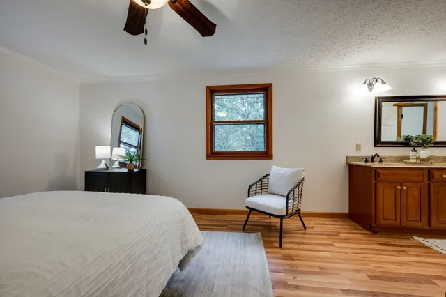 a bedroom with a bed and chair