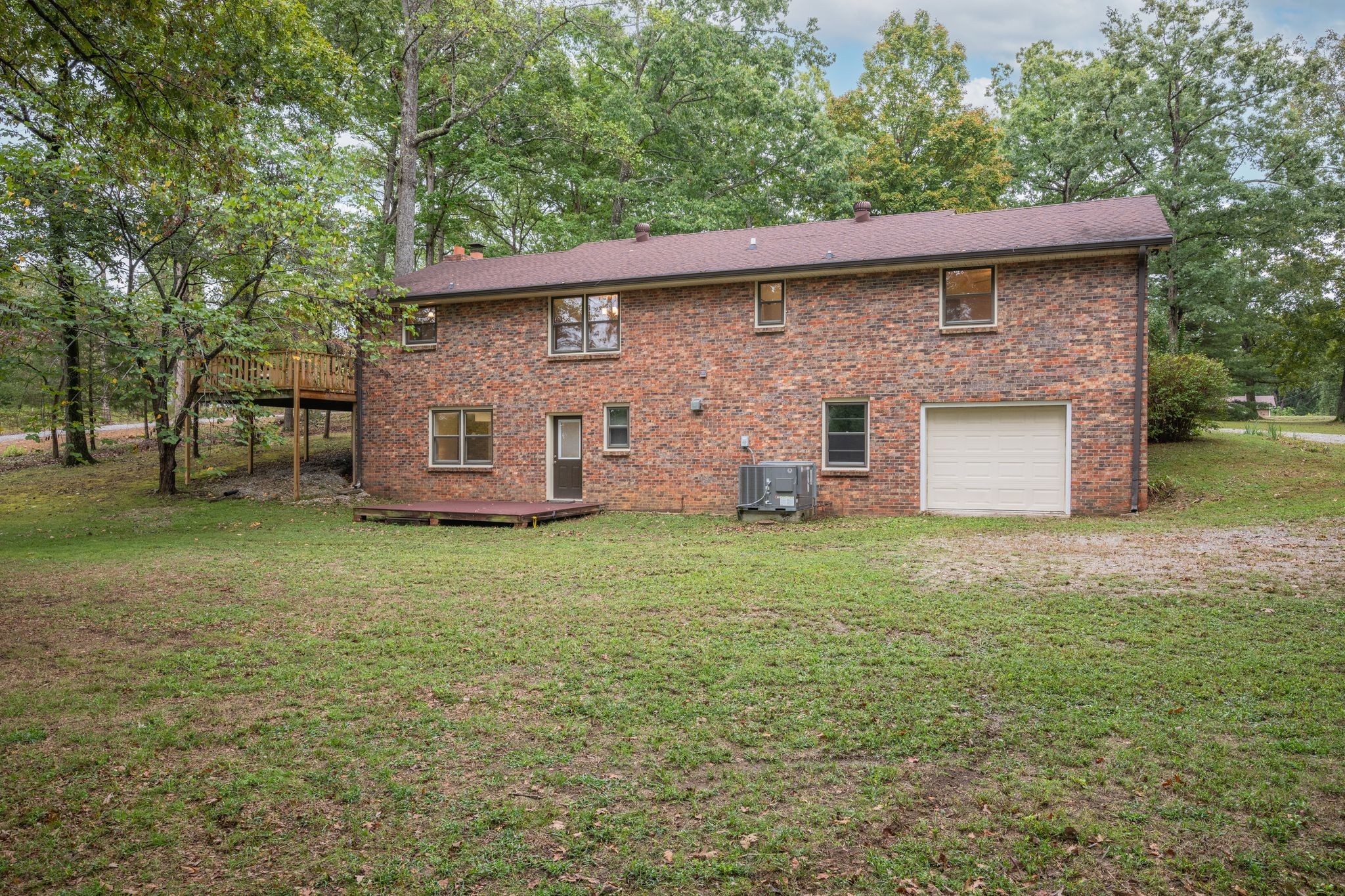 1085 Claylick Road White Bluff, TN 37187 - Photo 39 of 48 a backyard of a house with a garden and barbeque oven