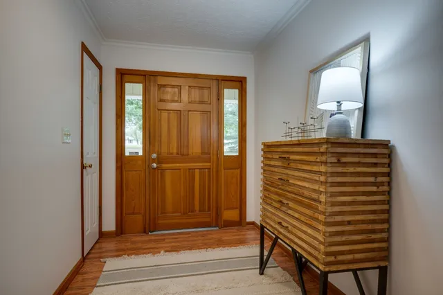 a view of a hallway with a door and bedroom view
