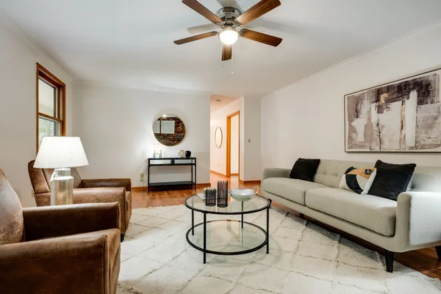 a living room with furniture a window and a lamp