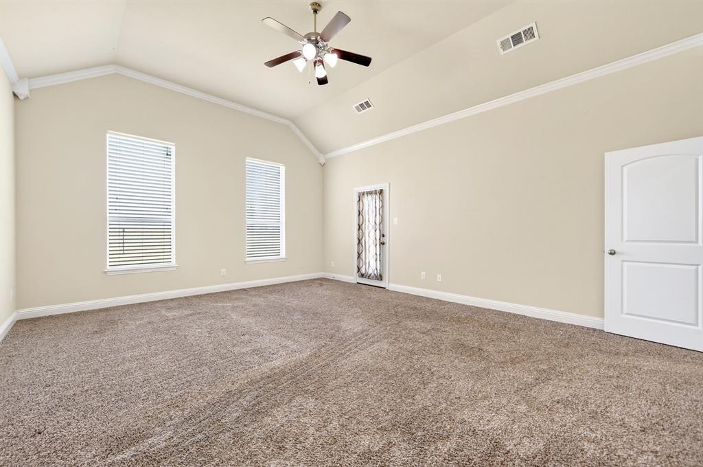 1836 County Road 5005 Blue Ridge, TX 75424 - Photo 11 of 28 Vaulted ceiling with crown molding, ceiling fan, and two windows with blinds. private doorway to covered back porch.