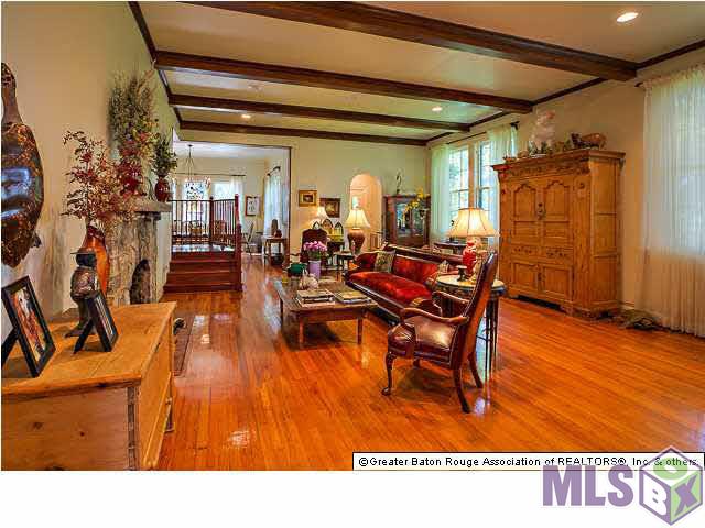 4150 Perkins Road Baton Rouge, LA 70808 - Photo 9 of 31 Living Room w/ fireplace bordered in the original limestone/quartz stones
