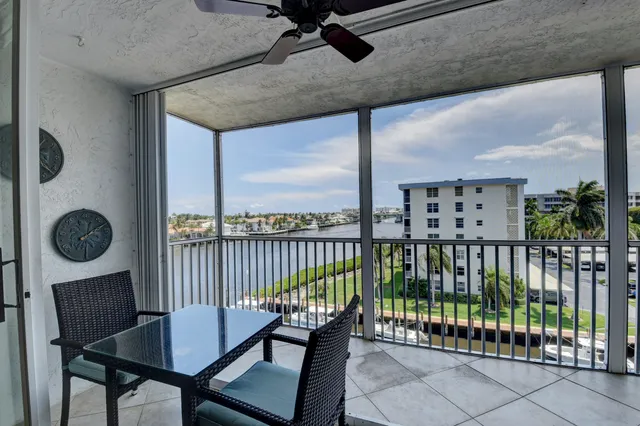 a bedroom with a bed a window and a chandelier
