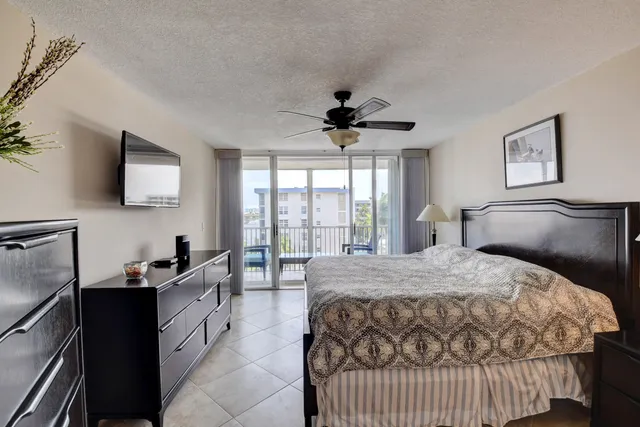 a view of a lake with boats and trees in the background