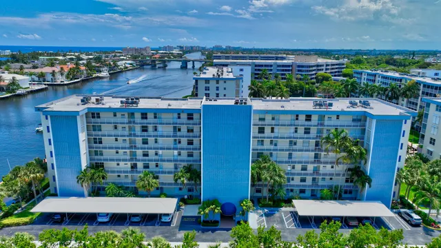 an aerial view of multi story residential apartment building with yard