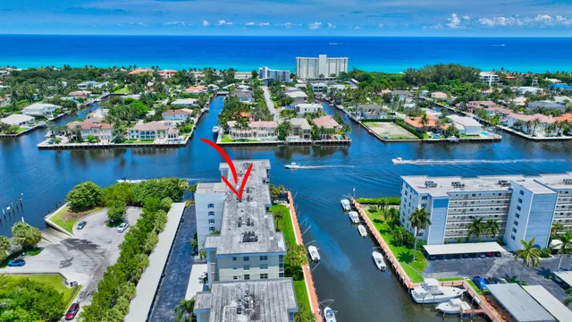 a view of a dining room with furniture a chandelier and wooden floor