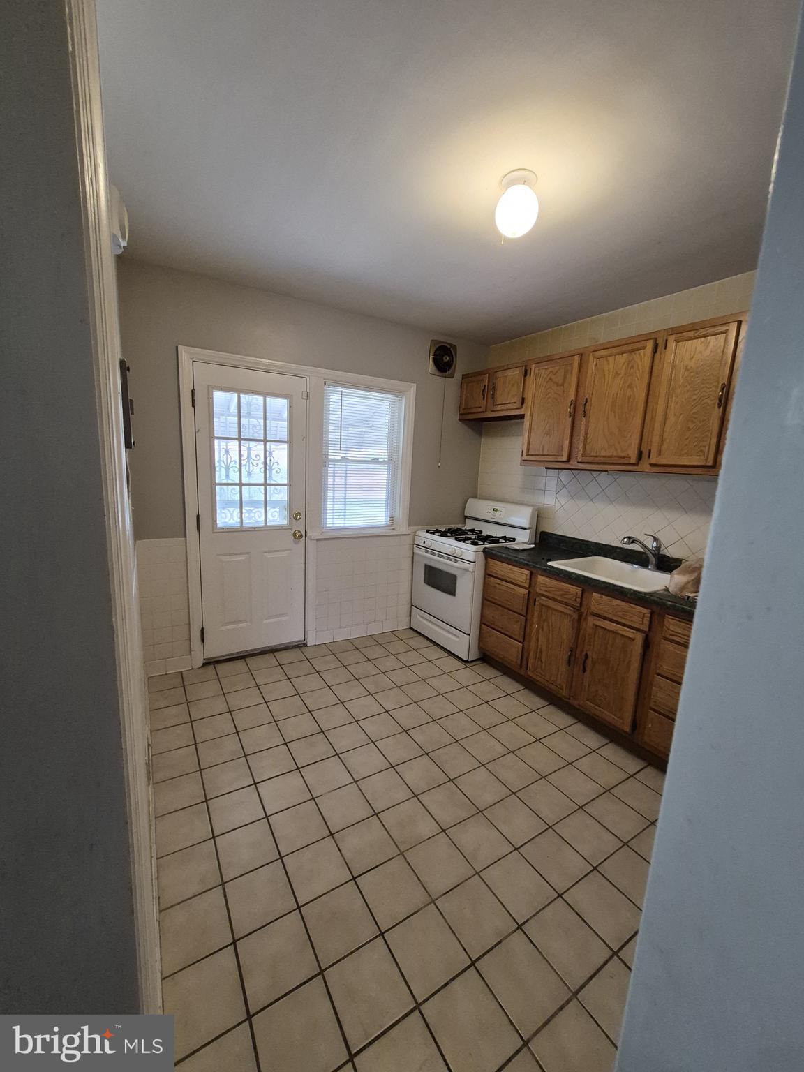 4905 Briarclift Road Baltimore, MD 21229 - Photo 11 of 41 a kitchen with stainless steel appliances a sink stove and cabinets