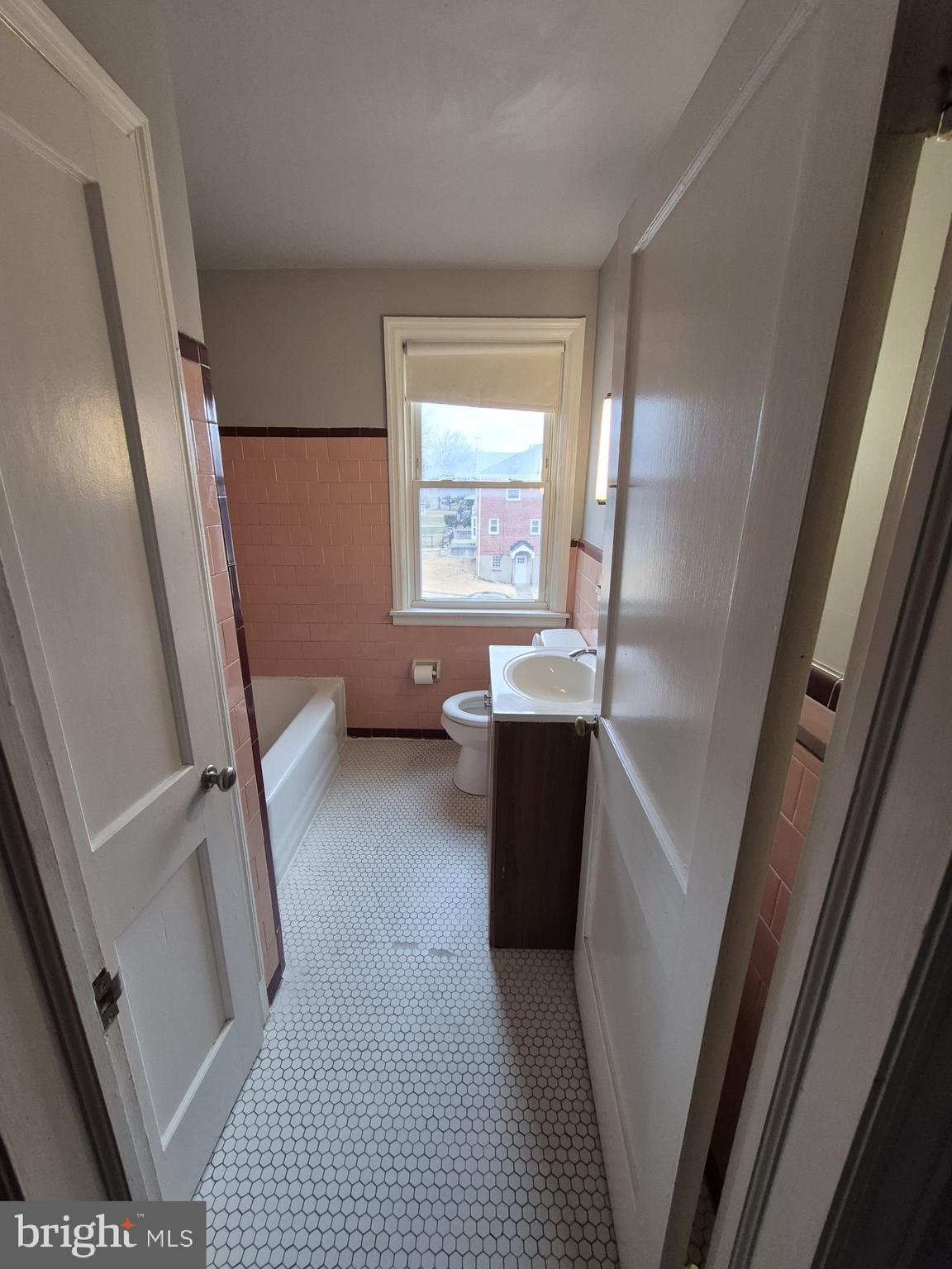 4905 Briarclift Road Baltimore, MD 21229 - Photo 24 of 41 a view of bedroom with window and wooden floor