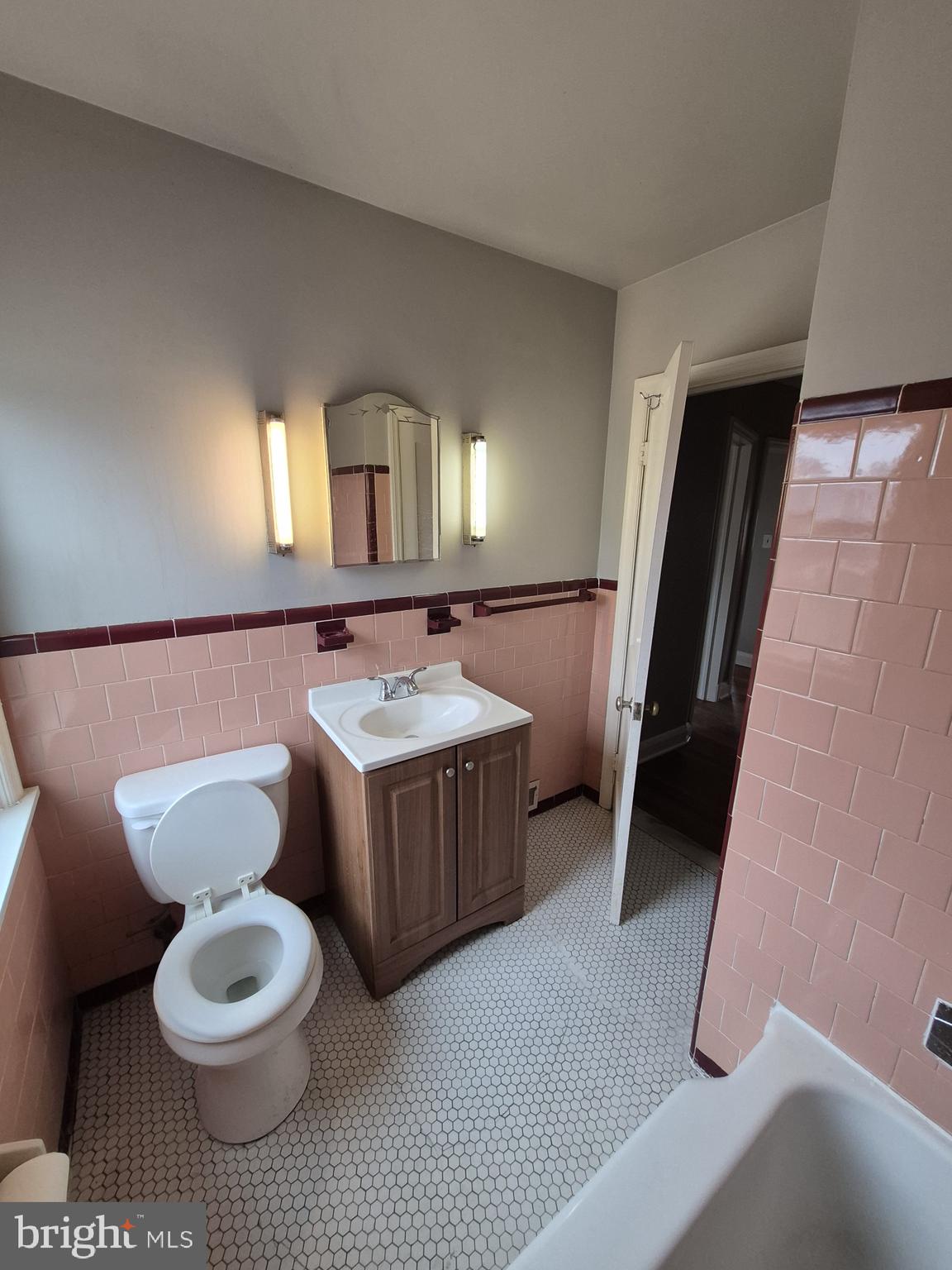 4905 Briarclift Road Baltimore, MD 21229 - Photo 26 of 41 a bathroom with a sink a toilet and a mirror