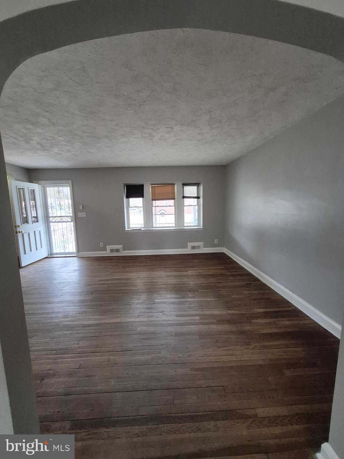 4905 Briarclift Road Baltimore, MD 21229 - Photo 4 of 41 a view of room with window and wooden floor