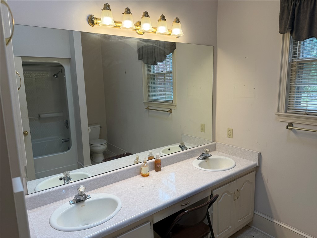 715 Concord Road Anderson, SC 29621 - Photo 13 of 24 A functional bathroom boasts a lengthy vanity with dual sinks, perfectly accommodating morning routines.