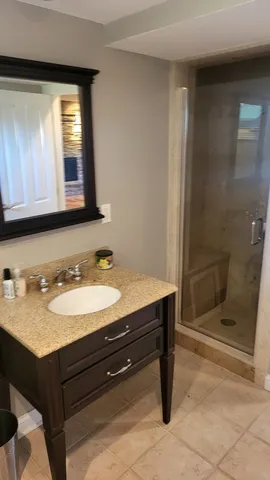 a bathroom with a sink a vanity and shower
