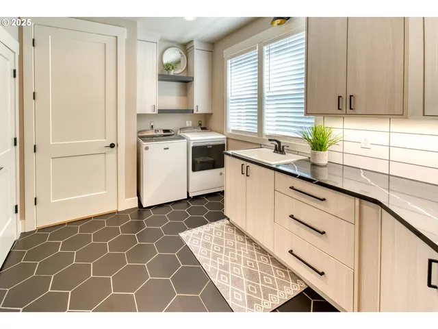 a kitchen with a sink cabinets and window