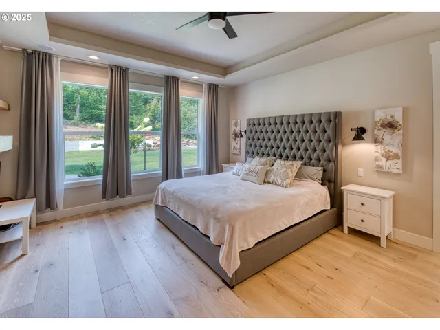 a bedroom with a large bed and a large window