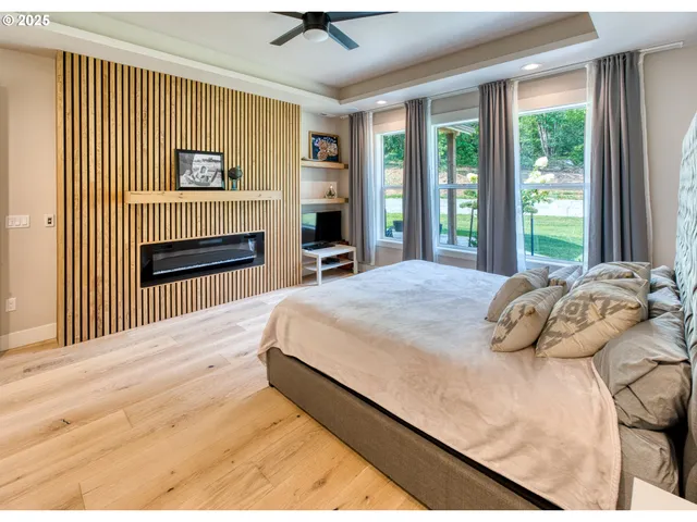 a bedroom with a bed and a flat tv screen