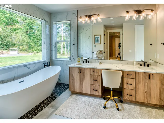 a bathroom with a sink mirror vanity and a bathtub