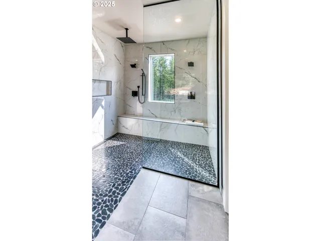 a bathroom with a glass shower door