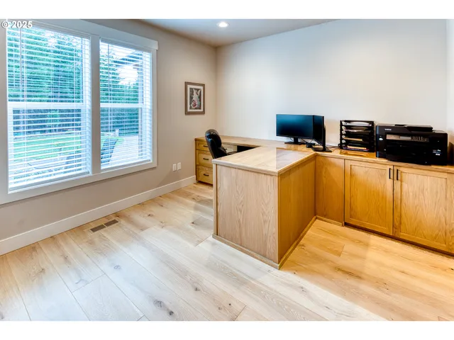 a view of a kitchen with wooden floor and a sink