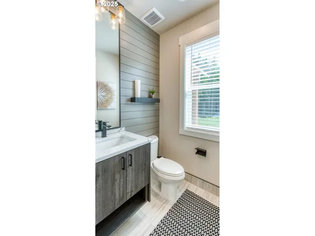 a bathroom with a sink toilet a mirror and vanity