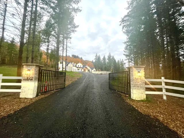 a view of a pathway with a wrought fence