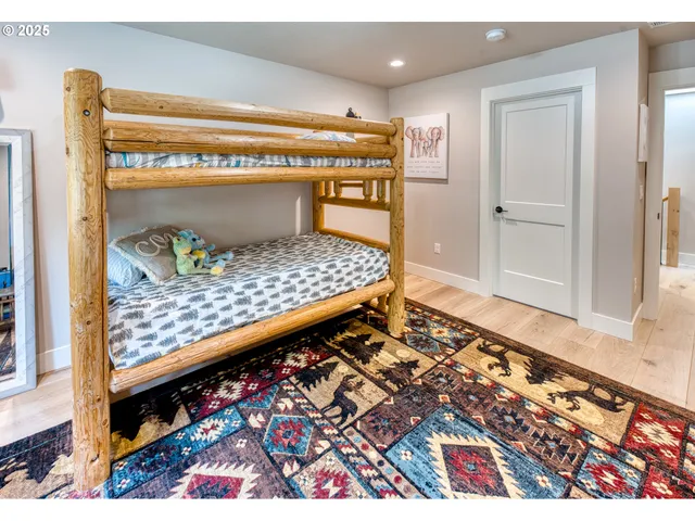 a bedroom with a bed and a painting on the wall