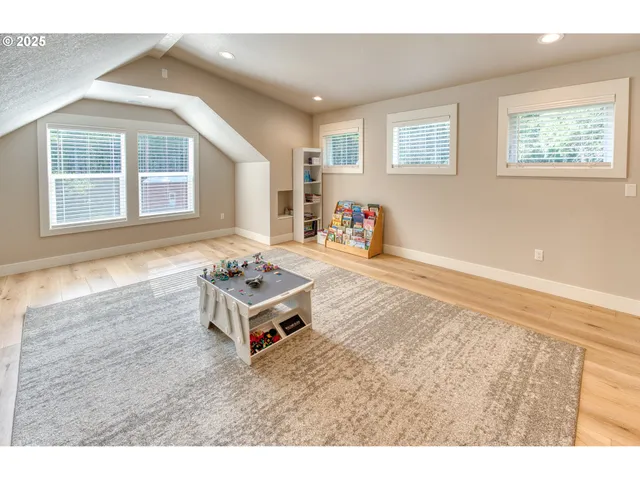 a living room with a dresser and a window