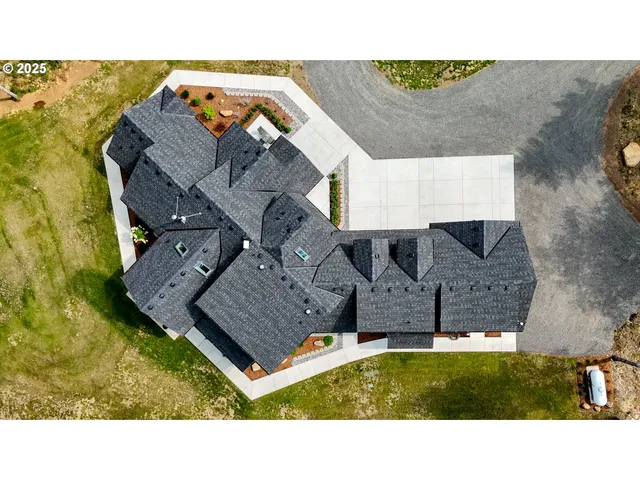 a aerial view of a house with a backyard