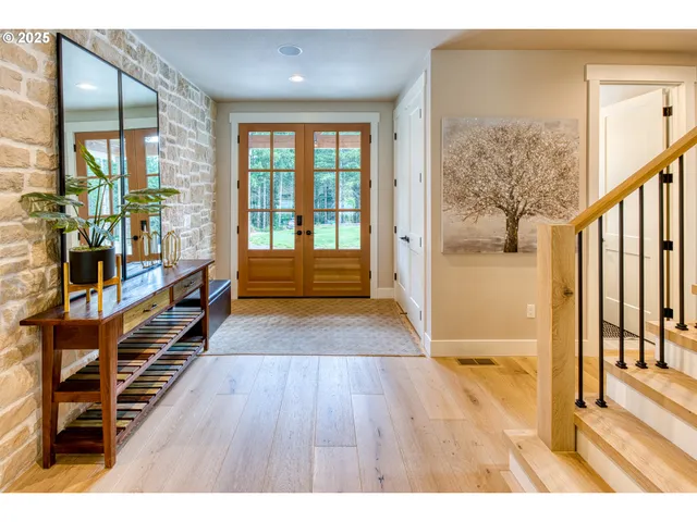 a hallway with wooden floor and furniture