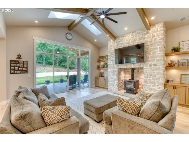 a living room with fireplace furniture and a flat screen tv