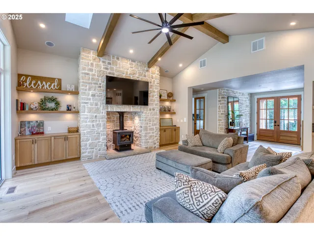 a living room with furniture a flat screen tv and a fireplace