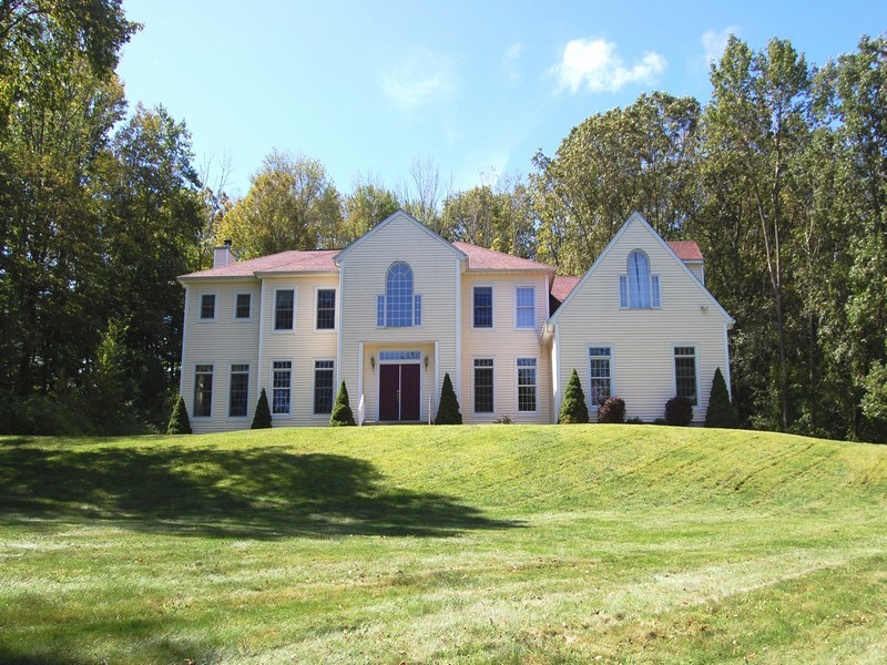 5 Cricklewood Road Redding, CT 06896 - Photo 1 of 16 a view of a white house with a big yard and large trees