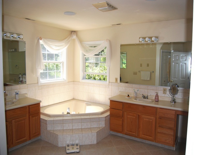 5 Cricklewood Road Redding, CT 06896 - Photo 10 of 16 a bathroom with a tub double sink window and mirror
