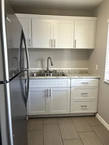 a kitchen with a sink and cabinets