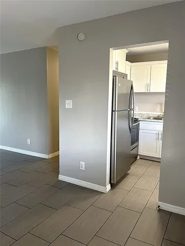 a kitchen with a refrigerator cabinet and a sink