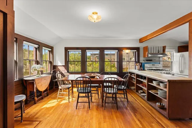 a view of a dining room with furniture window and wooden floor