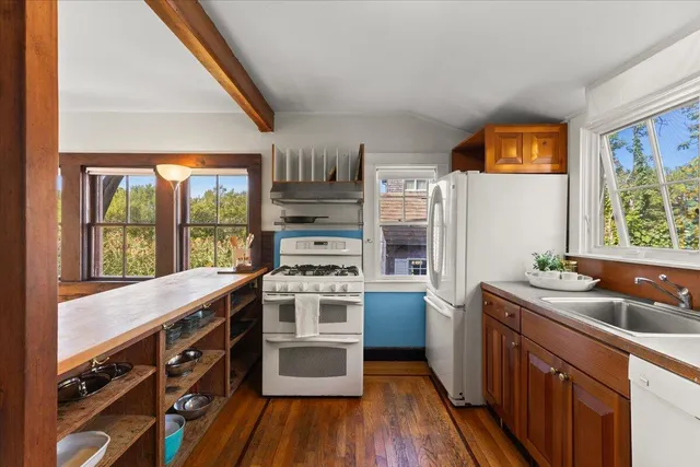 a kitchen with stainless steel appliances a stove a sink and a refrigerator