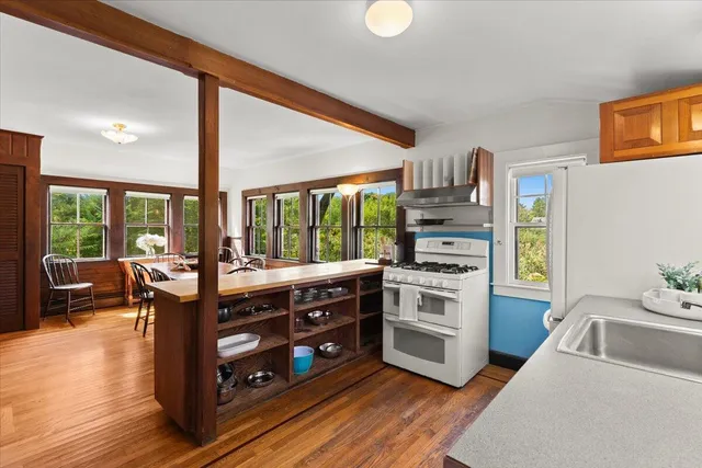 a kitchen with stainless steel appliances granite countertop a stove and a sink