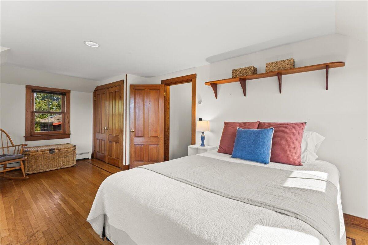 5 Park Road Woods Hole, MA 02543 - Photo 18 of 45 a bedroom with a large bed and wooden floor