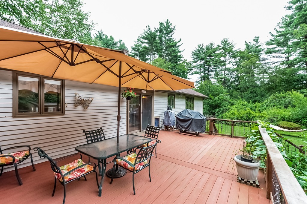 265 Andover Road Billerica, MA 01821 - Photo 21 of 30 a view of a patio with table and chairs under an umbrella