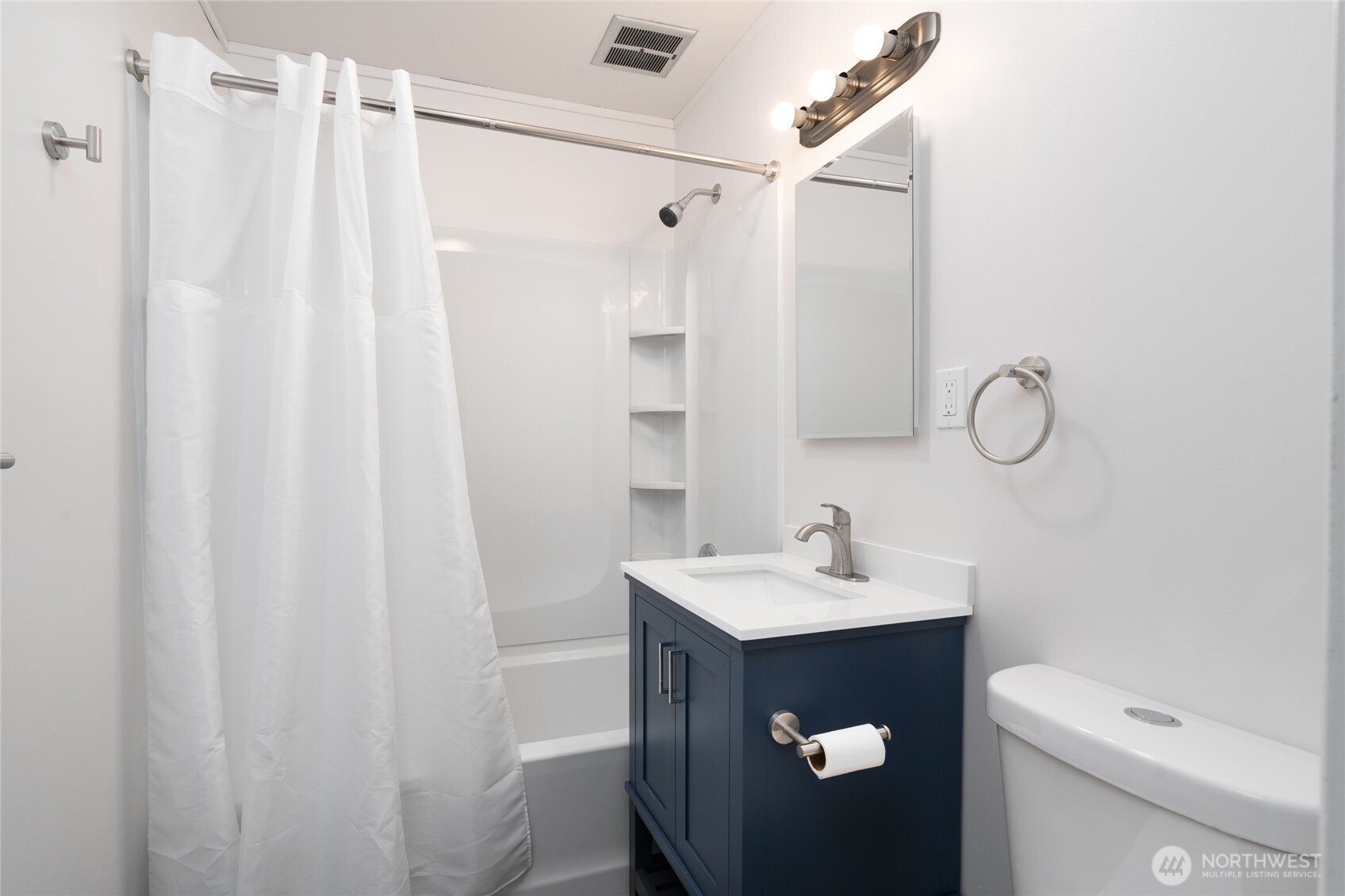 944 Fidalgo Street Sedro-Woolley, WA 98284 - Photo 19 of 28 a bathroom with a sink vanity mirror and toilet