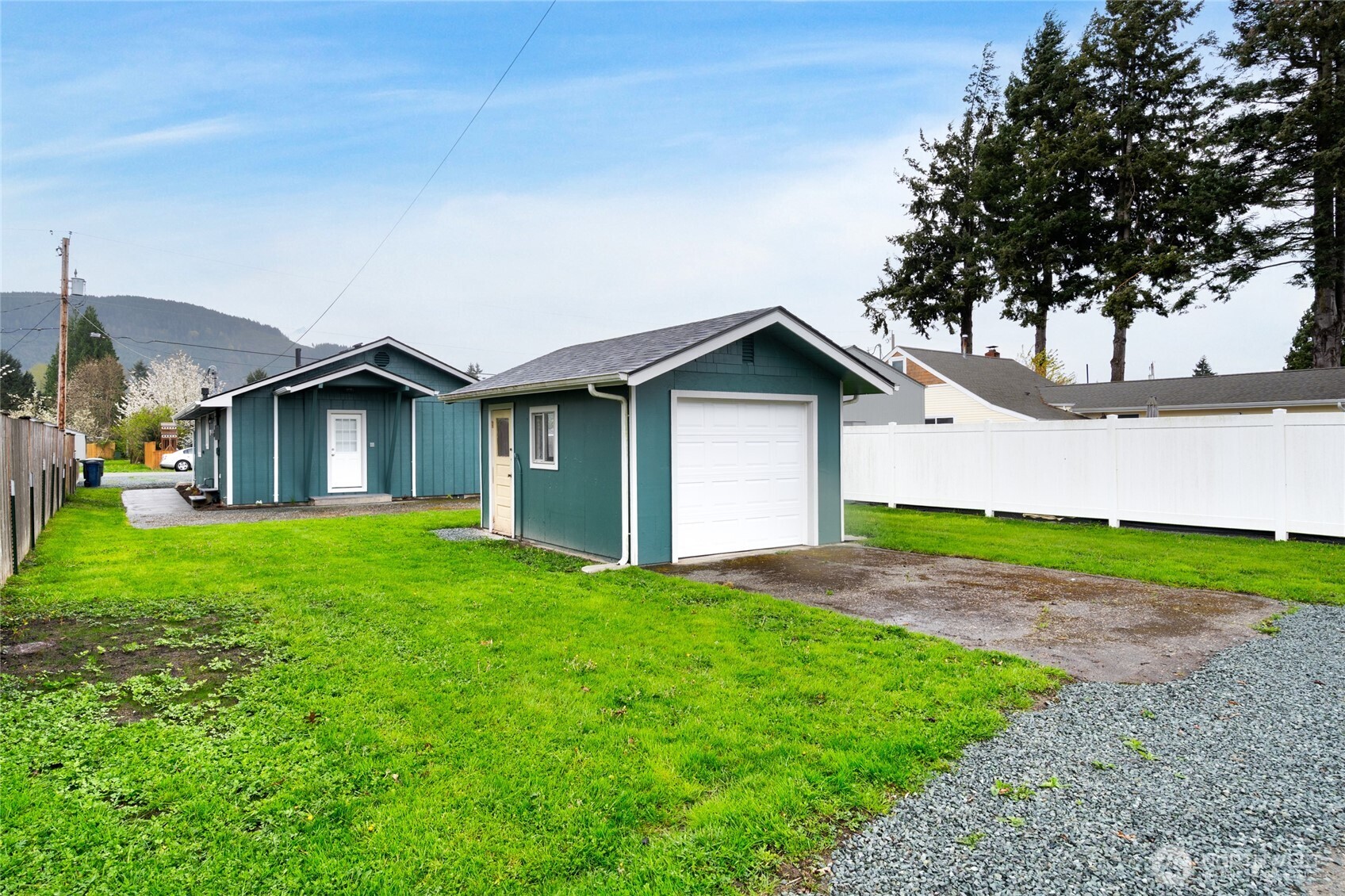 944 Fidalgo Street Sedro-Woolley, WA 98284 - Photo 22 of 28 a front view of a house with a yard and garage
