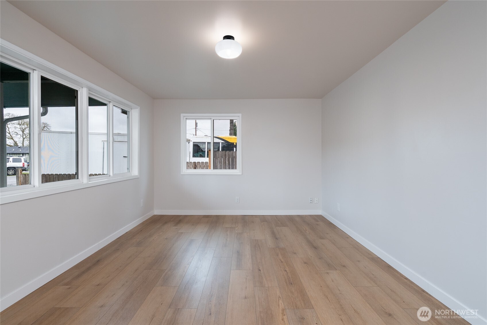 944 Fidalgo Street Sedro-Woolley, WA 98284 - Photo 6 of 28 wooden floor in an empty room with a window