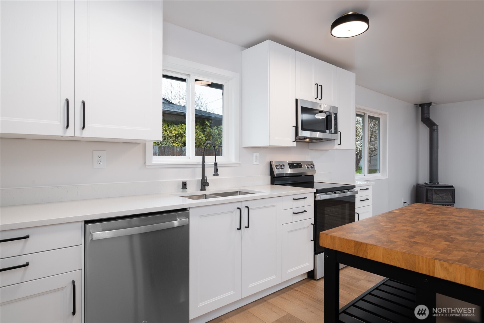 944 Fidalgo Street Sedro-Woolley, WA 98284 - Photo 10 of 28 a kitchen with stainless steel appliances granite countertop a sink stove and refrigerator