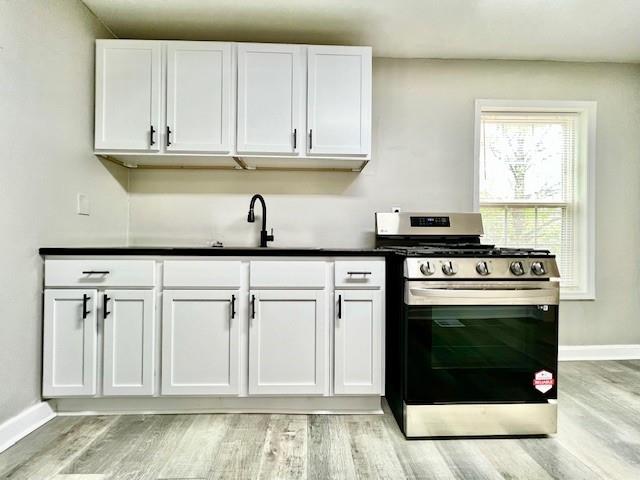 511 Emily Place Northwest Atlanta, GA 30318 - Photo 6 of 11 a kitchen with granite countertop a stove a sink and cabinets