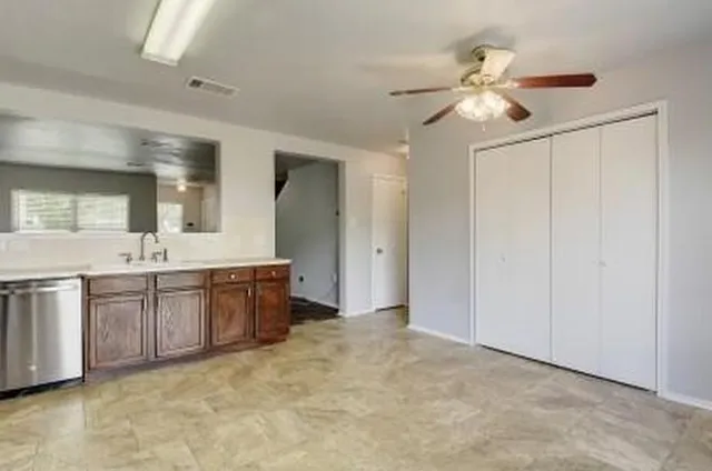 a spacious bathroom with a double vanity sink a mirror and a shower